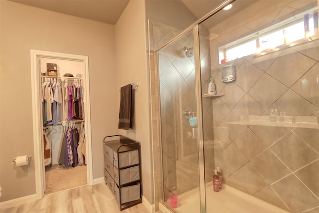 bathroom with walk in shower and hardwood / wood-style flooring