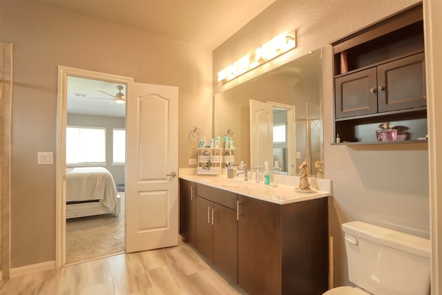 bathroom with ceiling fan, vanity, and toilet