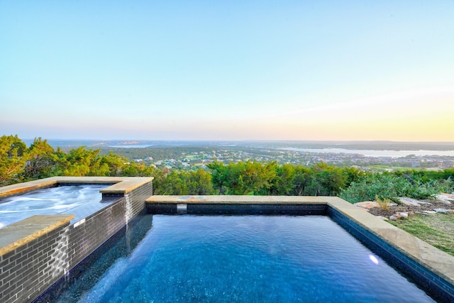 view of pool at dusk