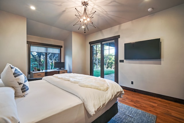 bedroom with a chandelier, access to outside, and dark wood-type flooring