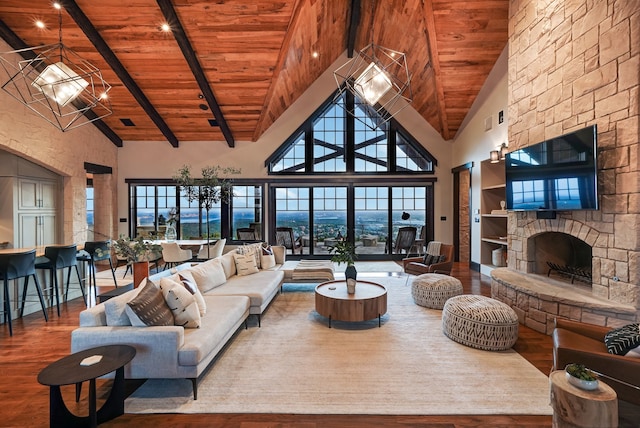 living room with a stone fireplace, high vaulted ceiling, hardwood / wood-style floors, beam ceiling, and wooden ceiling