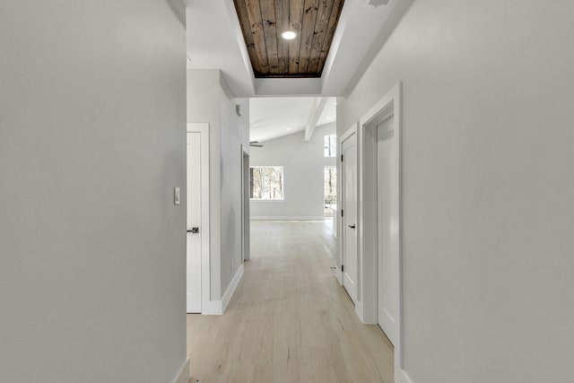 hallway featuring wooden ceiling, light hardwood / wood-style flooring, and vaulted ceiling