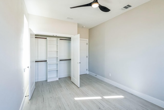 unfurnished bedroom with light wood-type flooring, a closet, and ceiling fan