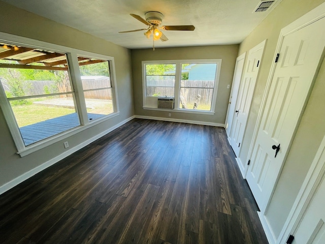 spare room with dark hardwood / wood-style floors and ceiling fan