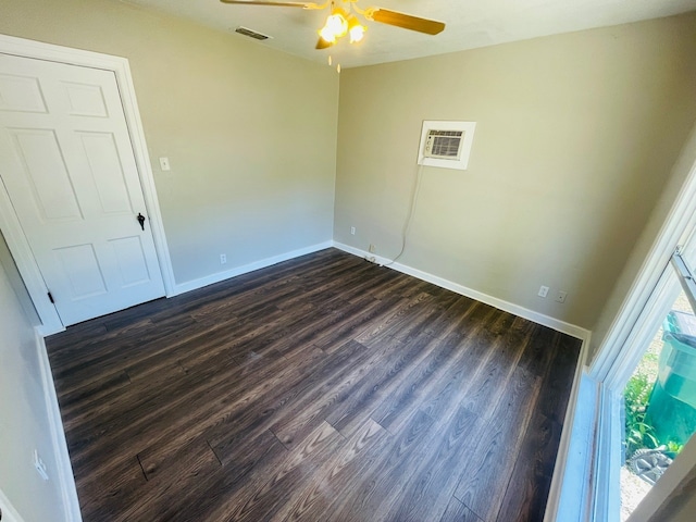 spare room featuring ceiling fan and dark hardwood / wood-style floors