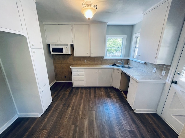 kitchen featuring dark hardwood / wood-style floors, tile countertops, and white cabinetry