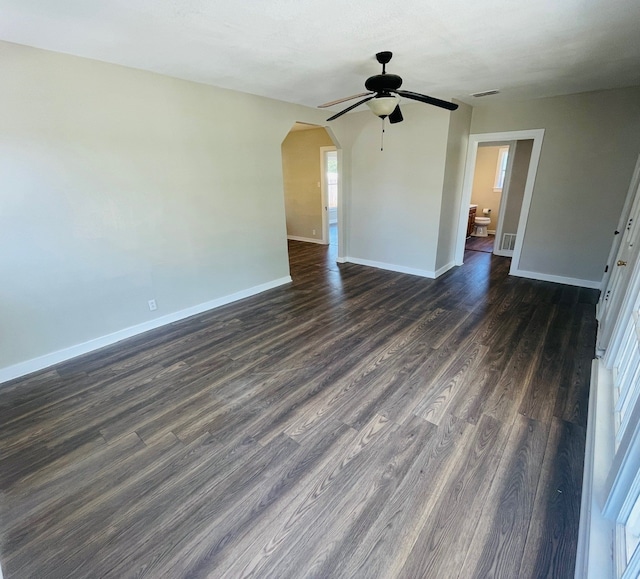 empty room with dark wood-type flooring and ceiling fan