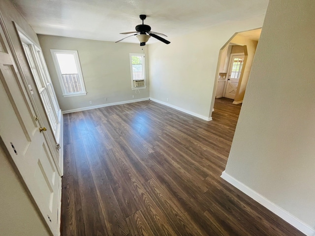 empty room featuring ceiling fan and dark wood-type flooring