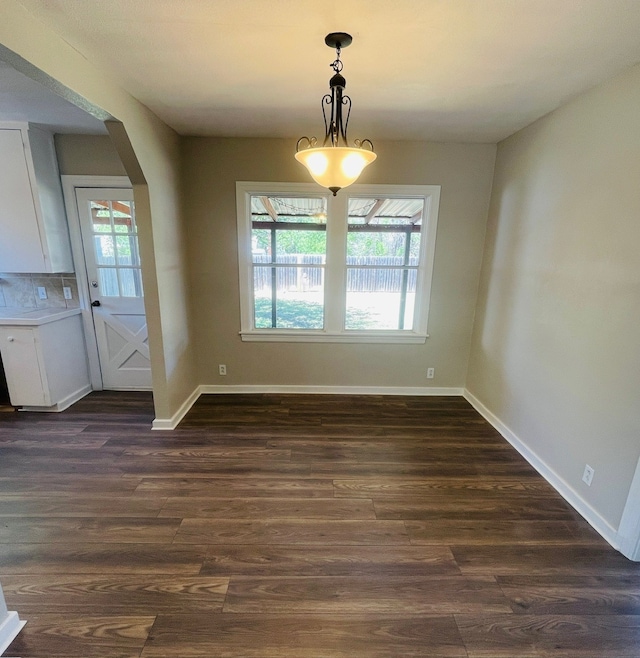 empty room with dark hardwood / wood-style flooring