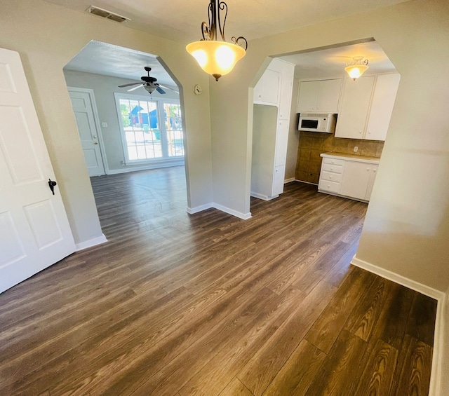 unfurnished room featuring ceiling fan and dark hardwood / wood-style floors