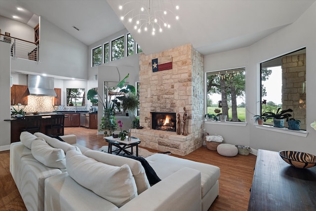 living area featuring baseboards, a fireplace, and light wood-style floors