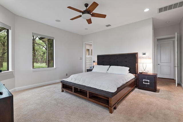 bedroom with baseboards, visible vents, light colored carpet, ceiling fan, and recessed lighting