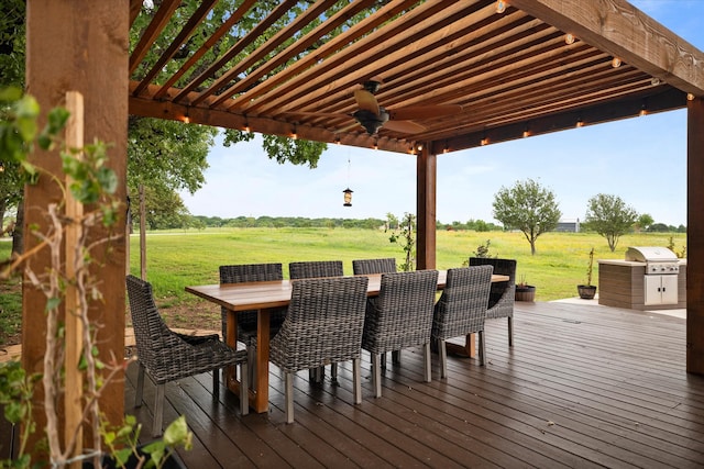 deck with ceiling fan, a pergola, a lawn, and area for grilling