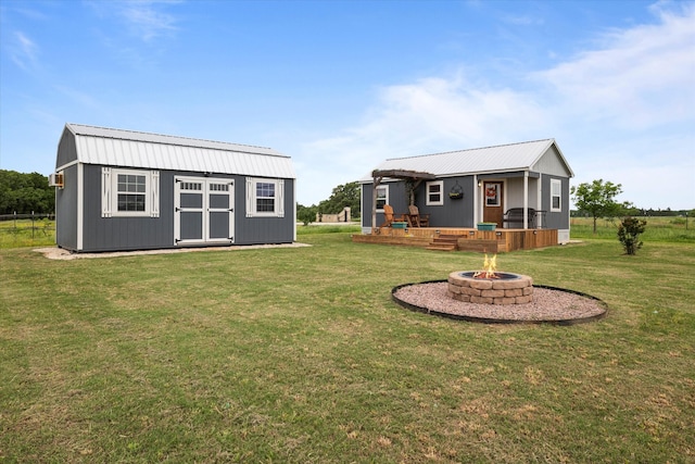 view of yard with a fire pit, a storage shed, and an outdoor structure