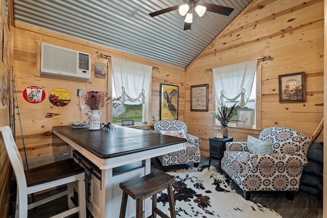 dining area featuring lofted ceiling, an AC wall unit, wood walls, and ceiling fan