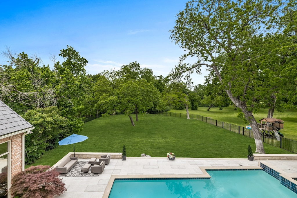 view of swimming pool featuring a yard and a patio