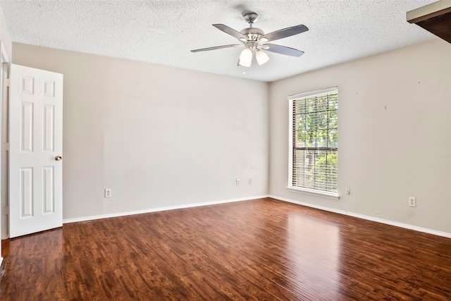 spare room with ceiling fan, a textured ceiling, and dark wood-type flooring