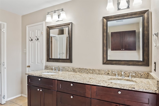 bathroom with double sink vanity and tile patterned flooring