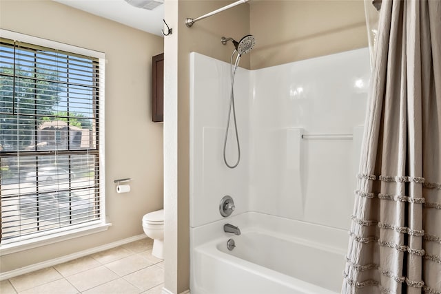 bathroom featuring tile patterned flooring, shower / tub combo, and toilet