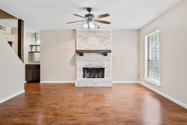 unfurnished living room featuring a wealth of natural light and wood-type flooring