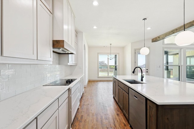 kitchen with sink, hanging light fixtures, stainless steel dishwasher, and tasteful backsplash