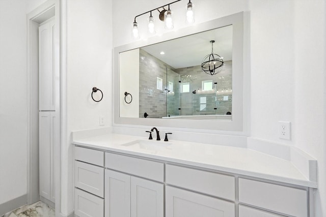 bathroom featuring a tile shower and vanity