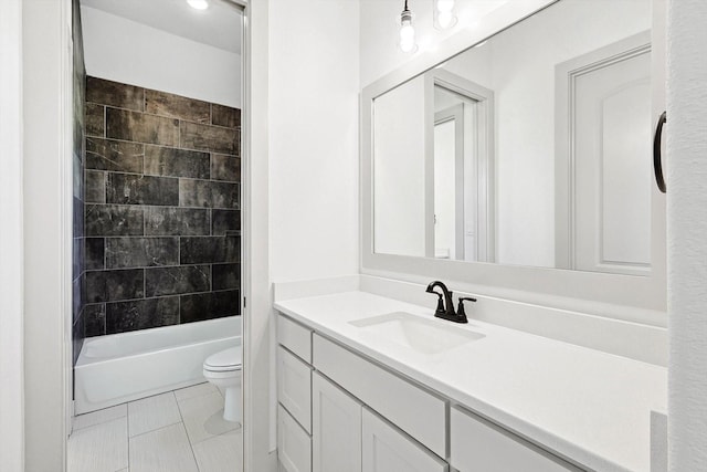 full bathroom with vanity, toilet, tiled shower / bath, and tile patterned flooring