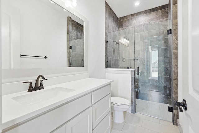 bathroom with walk in shower, vanity, toilet, and tile patterned flooring