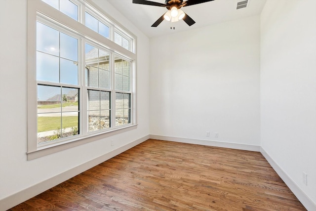 empty room featuring hardwood / wood-style flooring and ceiling fan