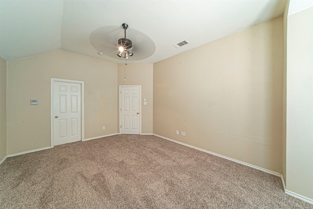 spare room featuring lofted ceiling, carpet floors, and ceiling fan