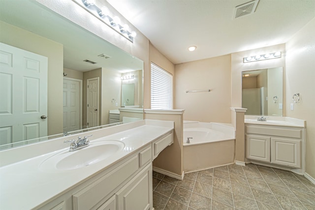 bathroom featuring a tub, large vanity, and tile floors