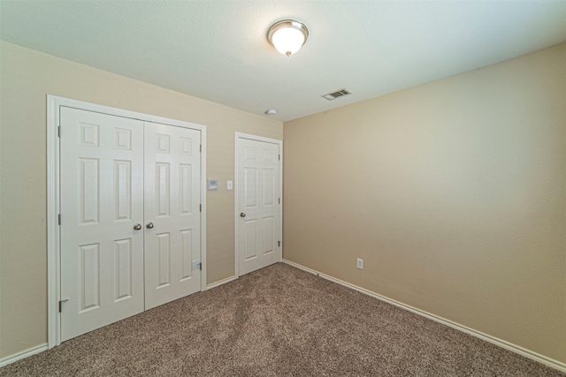 unfurnished bedroom featuring a closet and carpet flooring