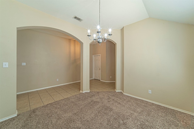 unfurnished room featuring tile flooring, vaulted ceiling, and an inviting chandelier