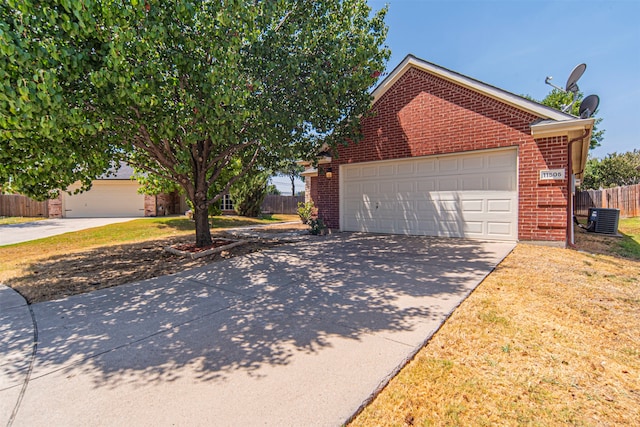 exterior space with a garage and central air condition unit