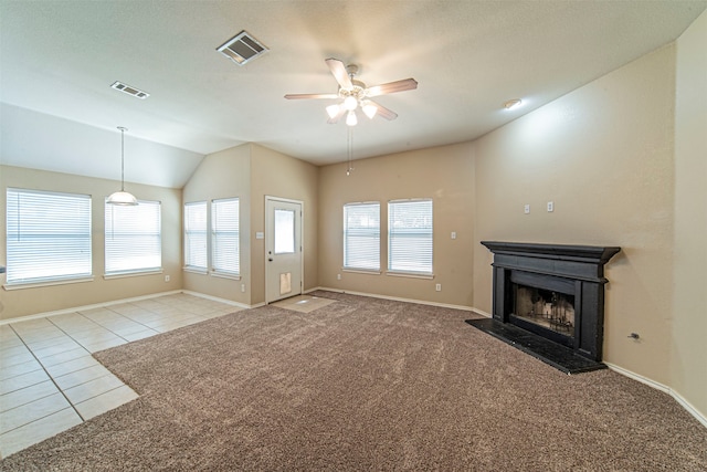 unfurnished living room with lofted ceiling, ceiling fan, and light tile floors