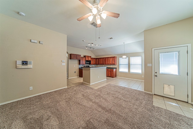 unfurnished living room with light carpet, vaulted ceiling, and ceiling fan