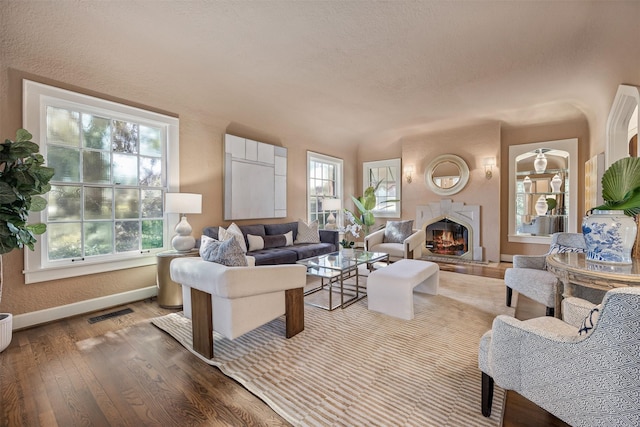 living room with a textured ceiling and light wood-type flooring