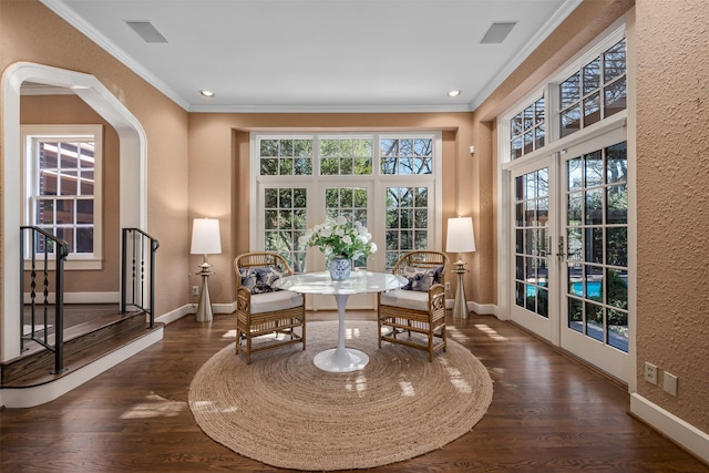 sitting room with dark hardwood / wood-style flooring, crown molding, and french doors