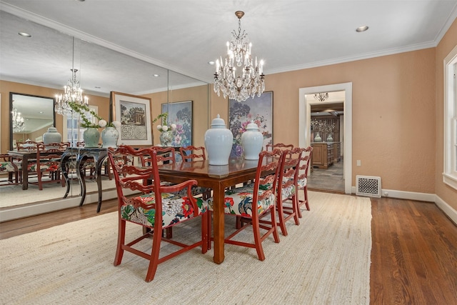 dining area featuring crown molding, wood-type flooring, and a notable chandelier