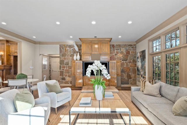 living room with light hardwood / wood-style flooring and ornamental molding