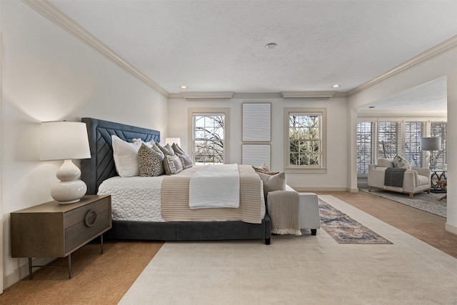 bedroom with ornamental molding, light colored carpet, and a textured ceiling