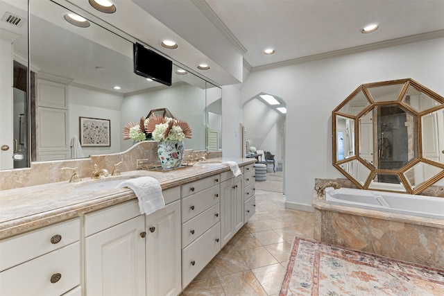 bathroom featuring vanity, a relaxing tiled tub, and crown molding