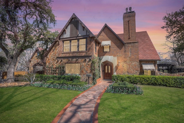 tudor-style house with a lawn