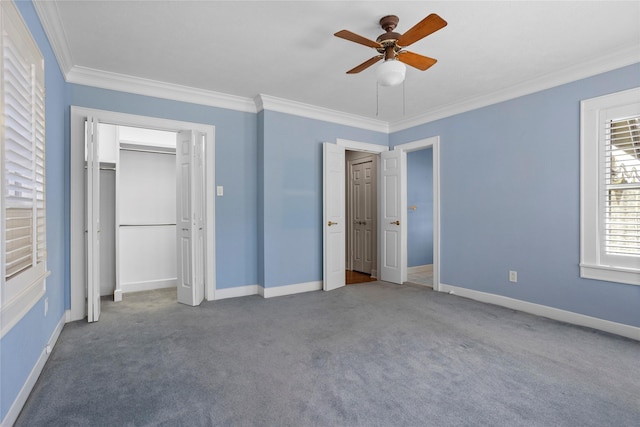 unfurnished bedroom with ornamental molding, carpet, and ceiling fan