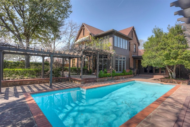 view of swimming pool featuring a patio area and a pergola