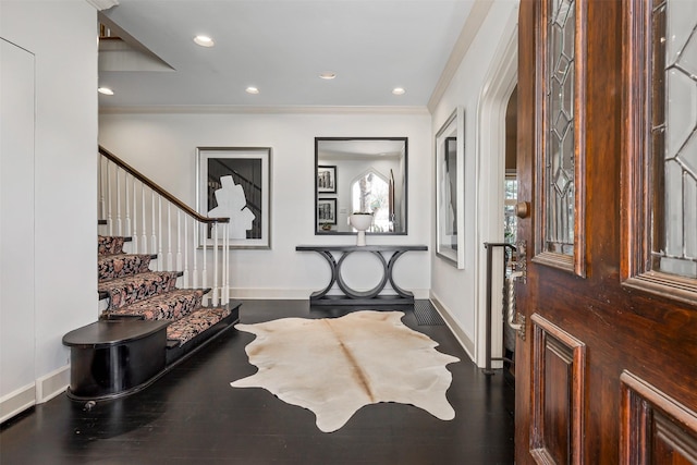 foyer featuring ornamental molding and dark hardwood / wood-style floors