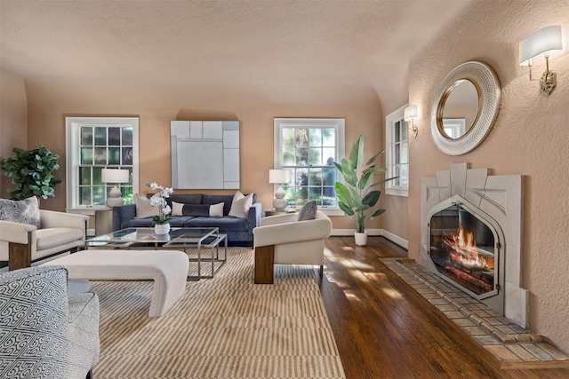 living room with hardwood / wood-style flooring and a textured ceiling