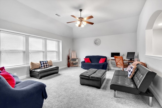 carpeted living room with ceiling fan and lofted ceiling