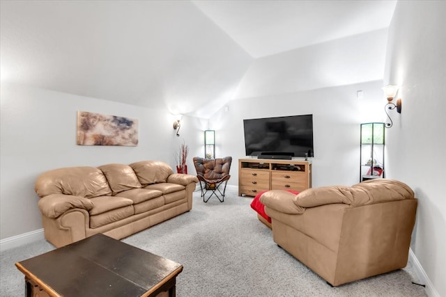 carpeted living room featuring vaulted ceiling