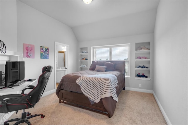 carpeted bedroom with connected bathroom and vaulted ceiling